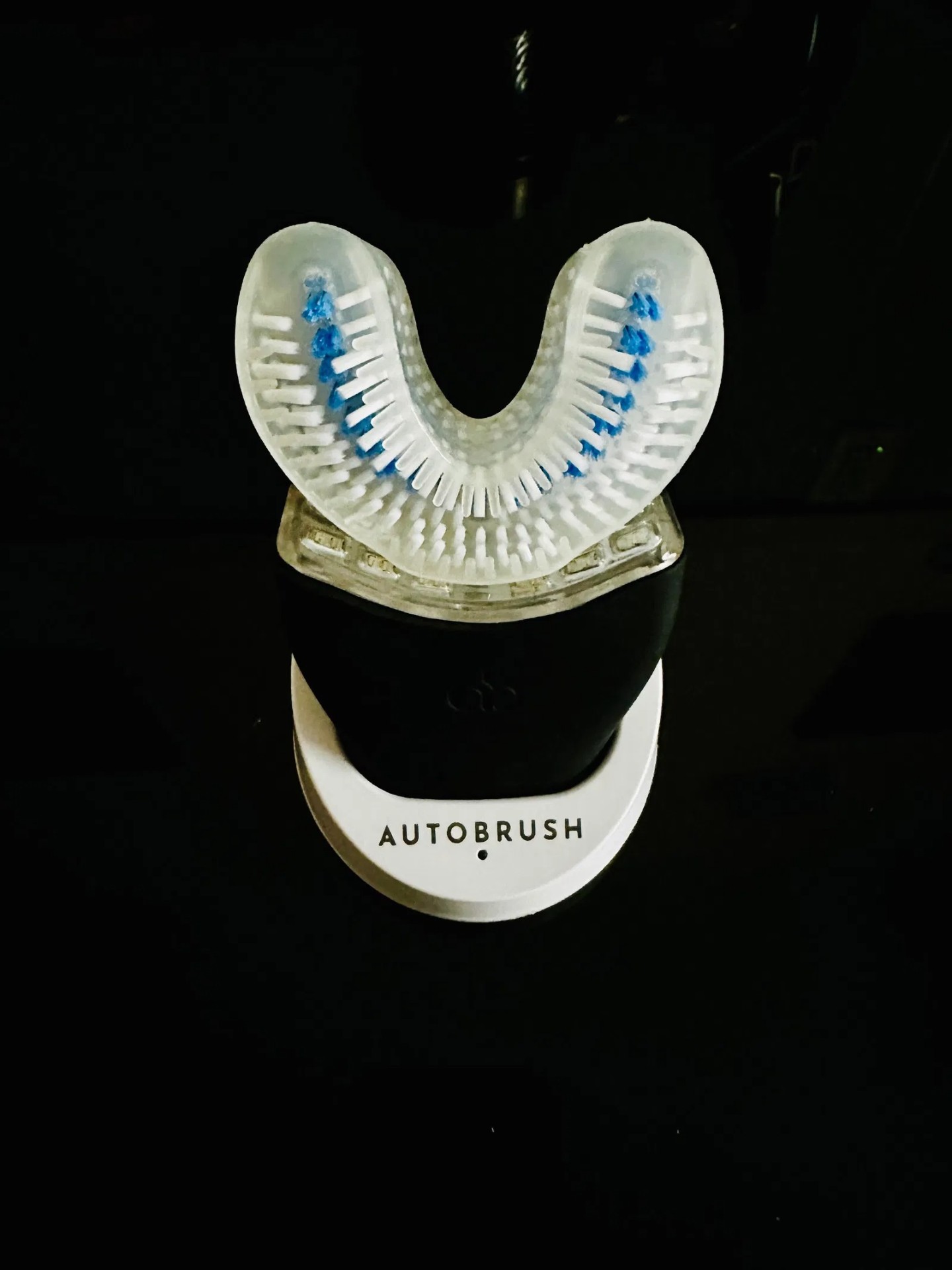 360° Sonic Electric Toothbrush on charging base at night